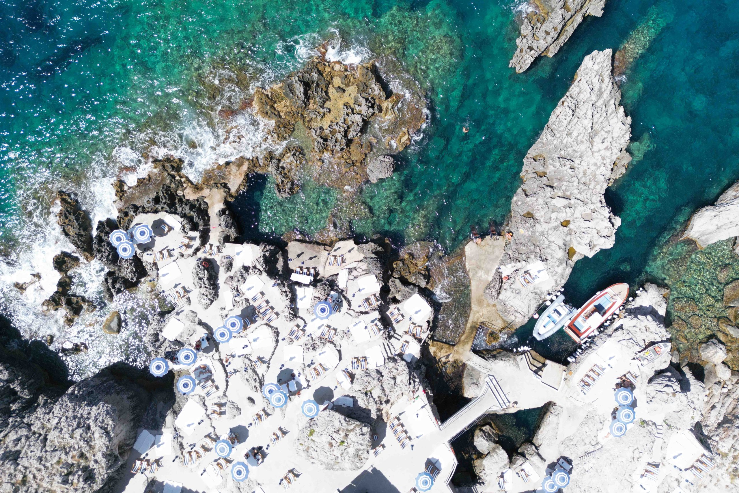 La Fontelina beach club on the cliffs of Capri above the Mediterranean Sea